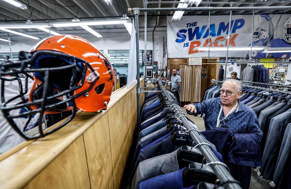 Austin Burke co-owner Kenny Sager organizes the racks inside the store he’s run with Burke’s son Barry Burke for decades on Jan. 10, 2025.