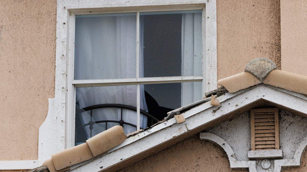 View of a broken window damaged by a pair of tornadoes that tore through the Portofino Shores Community, hours before Hurricane Milton made landfall on Florida’s west coast on Wednesday October 9, 2024.  