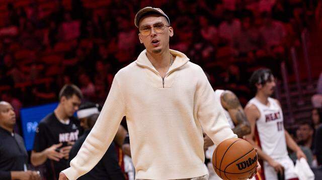 Miami Heat guard Tyler Herro (14) dribbles a ball on the sidelines during the first half of an NBA preseason game against the Milwaukee Bucks at Kaseya Center on October 6, 2025, in Miami.