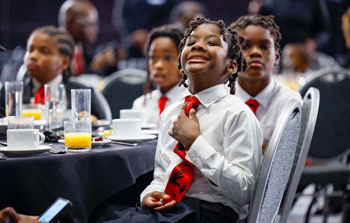 Zaccheus Smith, 10, adjusts his tie during the 5000 Role Models of Excellence Foundation’s 32nd Annual Dr. Martin Luther King, Jr. scholarship breakfast in the Miami Beach Convention Center.