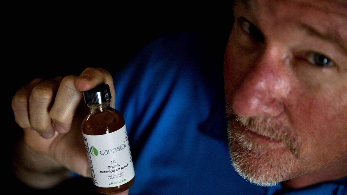 Former Georgia state Rep. Allen Peake, a Macon Republican, holds a bottle of low-THC cannabidiol oil in his office.