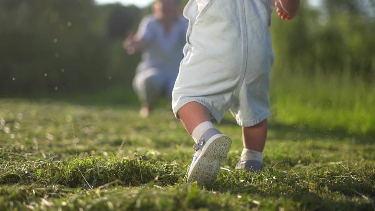 toddler taking first steps