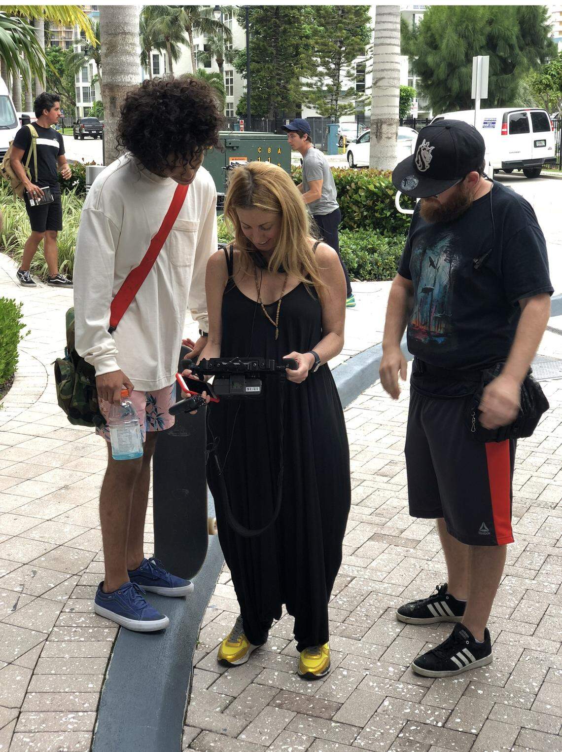 From left, actor Tyler Dean Flores, director Jessica Kavana Dornbusch and prop master Craig Lederman on the set of ‘Reefa,’ a film based on the life of the late graffiti artist Israel ‘Reefa’ Hernandez Jr. The movie was shot on location in 2019 in Miami and Miami Beach and is now airing on HBO MAX.