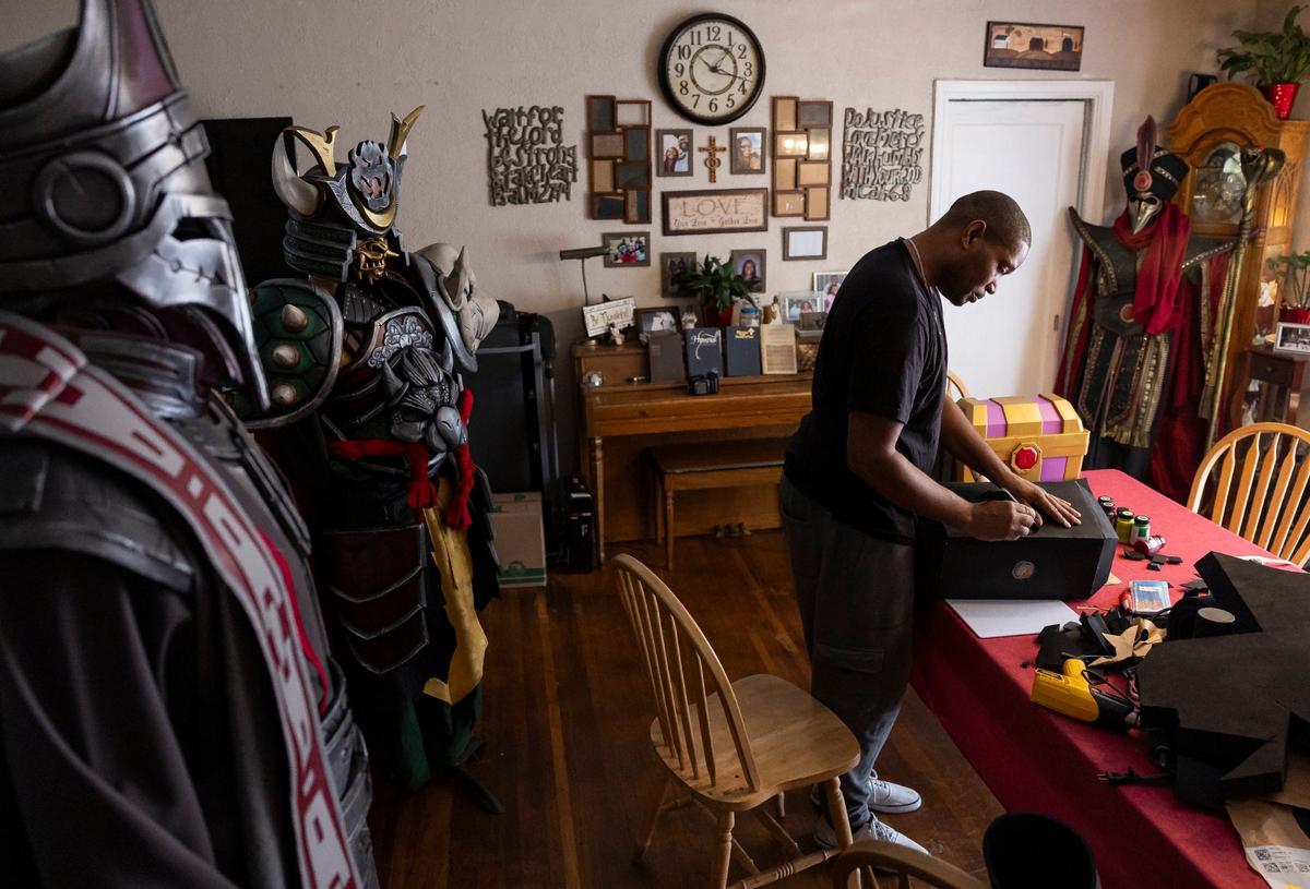 Matthew Harden designs a hammer for his costume for this year’s Florida Supercon at his sister’s house in North Miami.