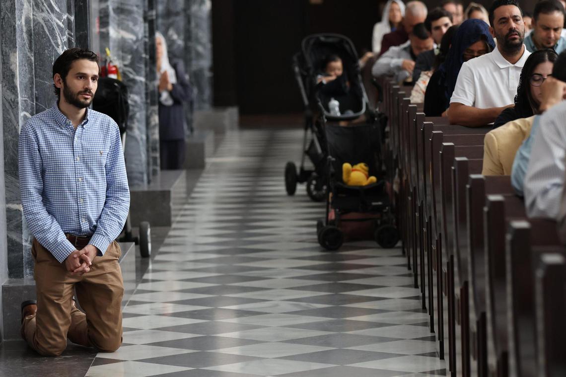 Andres Solorzano, left, kneels in prayer during a Traditional Latin Mass Sunday morning service at Our Lady of Belen Chapel on July 30, 2023.