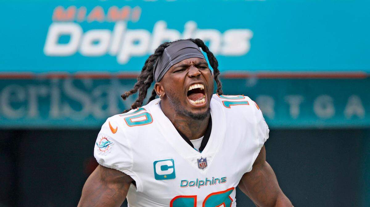 Miami Dolphins wide receiver Tyreek Hill (10) reacts as he runs onto the field during introductions before the start of the game against the Houston Texans at Hard Rock Stadium in Miami Gardens on Sunday, November 27, 2022.