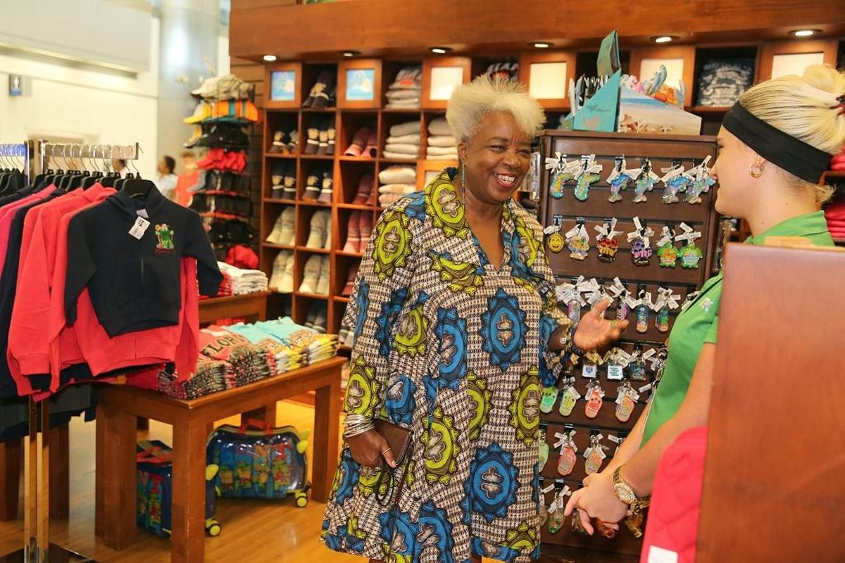 Carole Ann Taylor, left, founder and owner of Cultures to Go, chats with Lazara Alvarez, a sales rep at Taylor’s store Miami To Go at Miami International Airport.