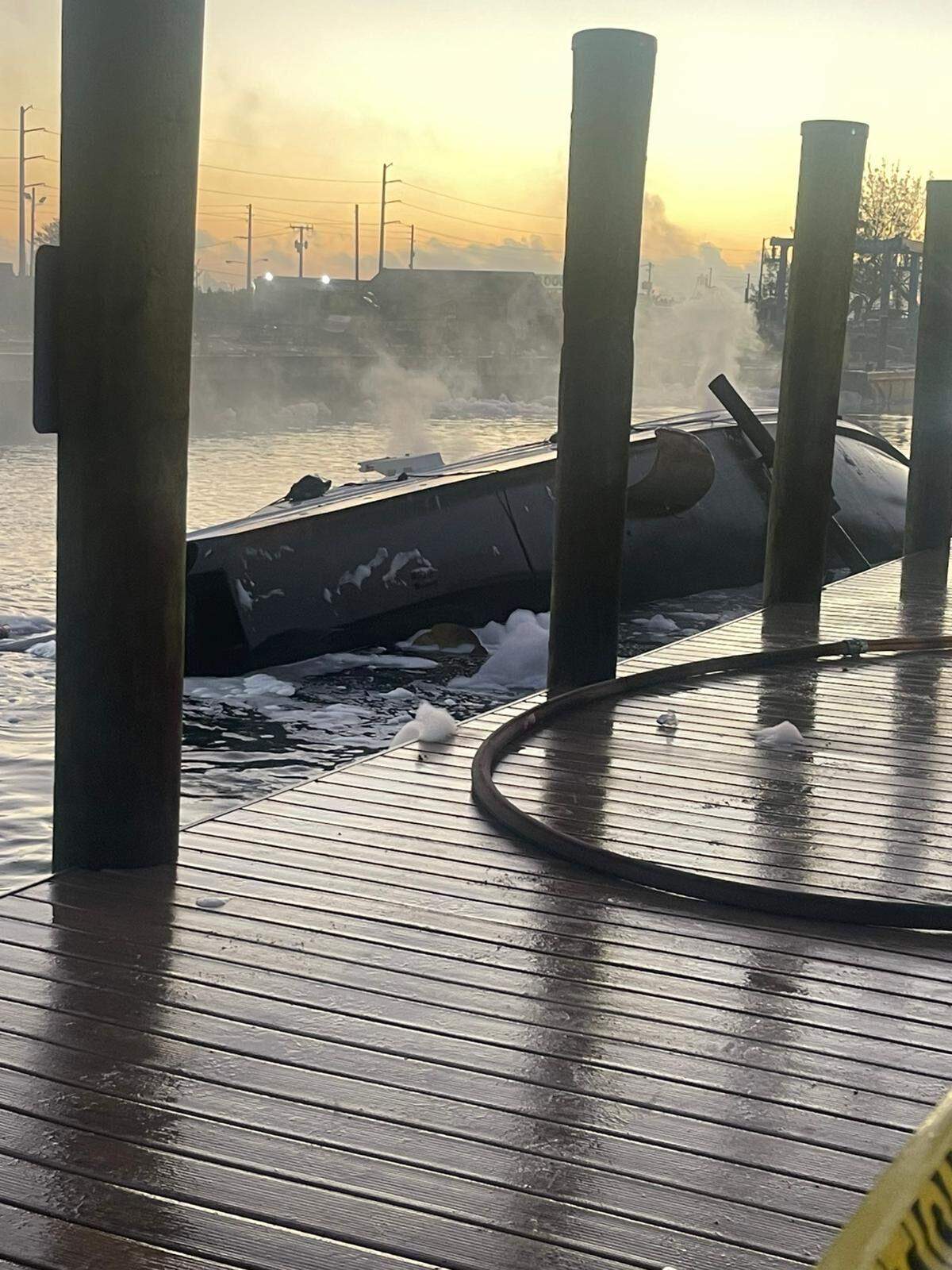 The remains of the yacht in the Miami River outside Booby Trap on The River.