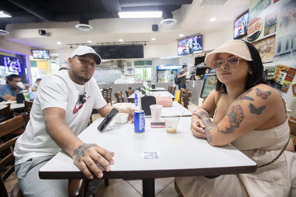 Venezuela’s Cristian Mota and Yulyhec Echeverría speak with a Miami Herald reporter at El Arepazo in Doral, Monday, July 29, 2024, about the results of the presidential election. Amid allegations of fraud, Nicolás Maduro was re-elected as Venezuela’s president.