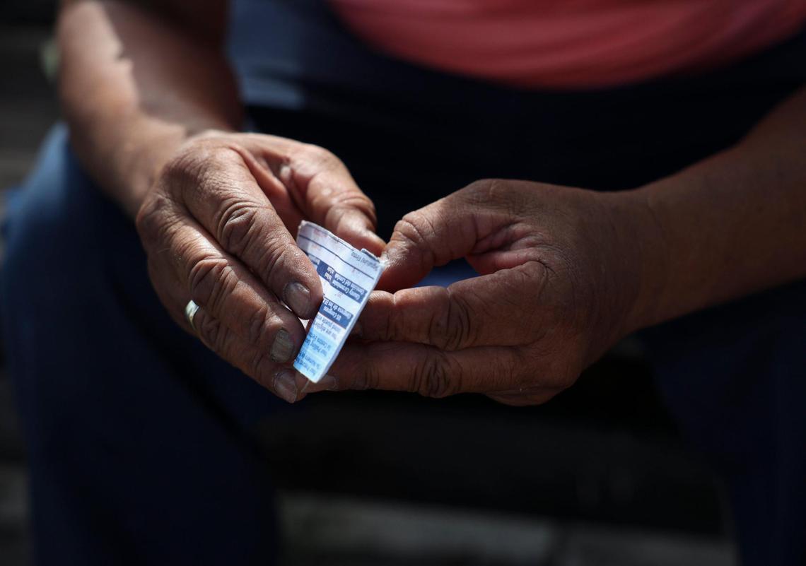 Robert Simpson, a Pahokee resident charged with election fraud, holds the voter ID card he received after registering to cast a ballot. Simpson said he didn’t know he was banned from voting because of a murder conviction. State and county officials didn’t realize either and allowed him to register.