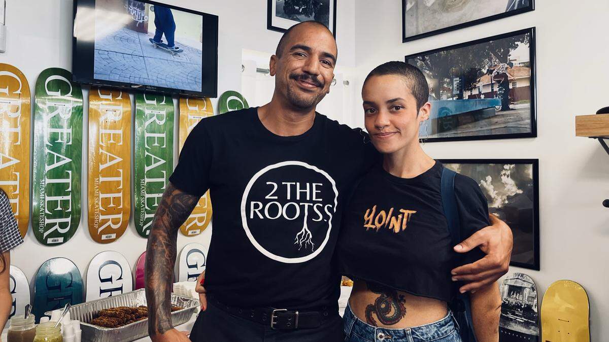 Gabriel Lopez and Erica Denis in front of a catered serving of their homemade croquetas at the Grand Opening of Greater Skate Shop.