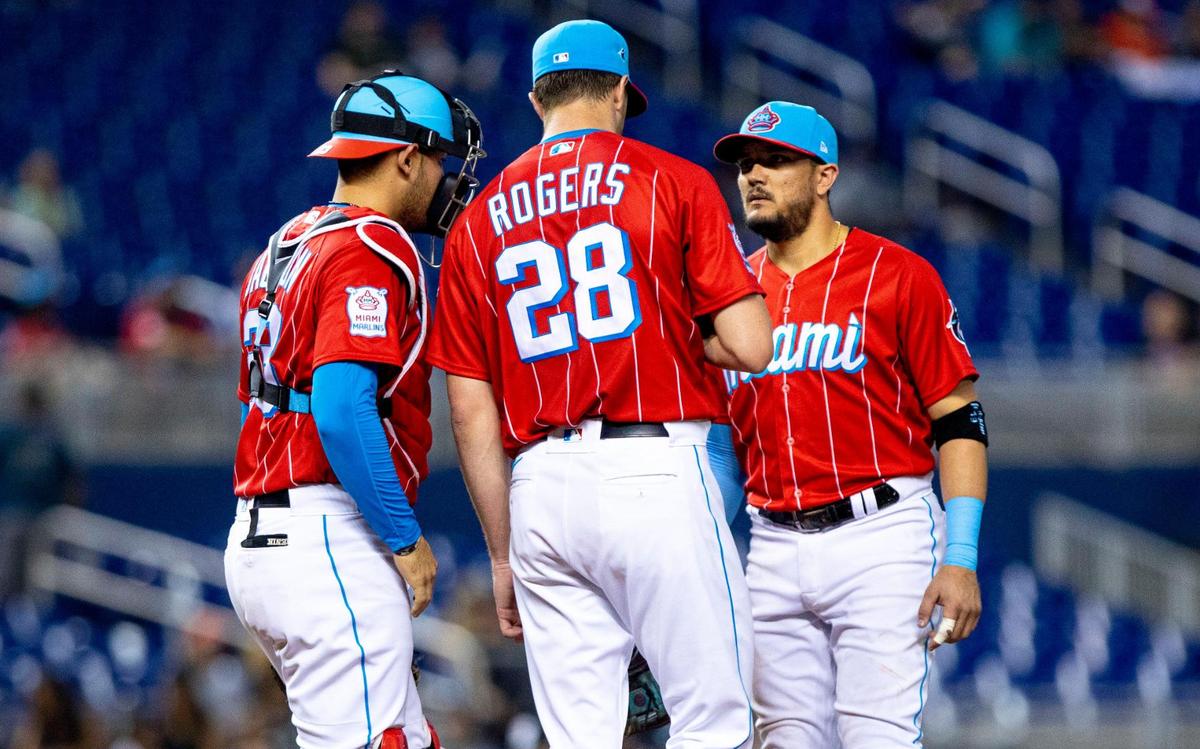 Miami Marlins pitcher Trevor Rogers (28) is visited at the mound by teammates during the fourth inning of an MLB game against the Philadelphia Phillies at loanDepot park in the Little Havana neighborhood of Miami, Florida, on Saturday, September 4, 2021