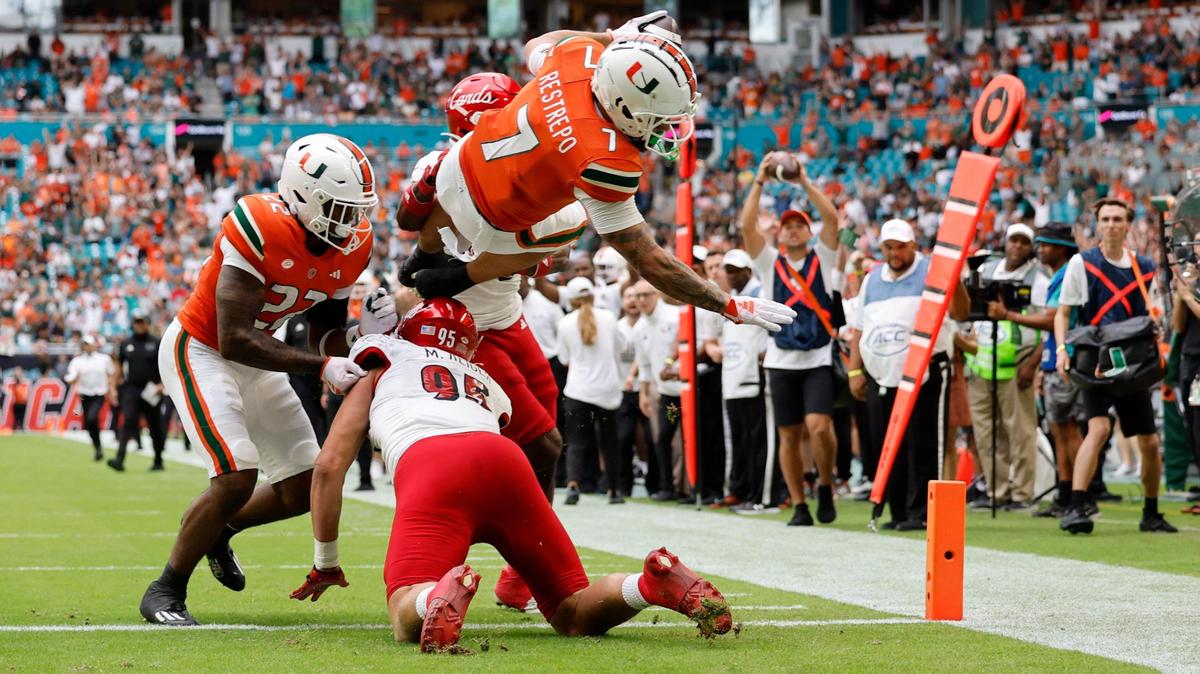 Miami Hurricanes wide receiver Xavier Restrepo (7) scores in the first half against the Louisville Cardinals on Saturday, November 18, 2023.