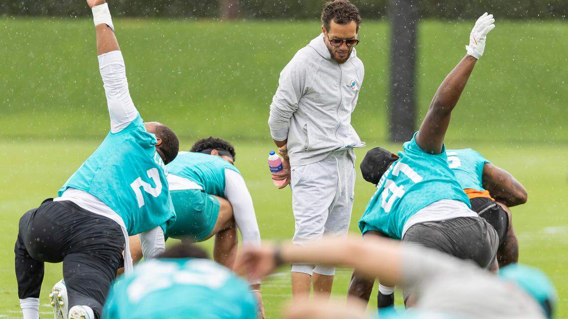 Miami Dolphins head coach Mike McDaniel talks with linebacker Channing Tindall (41) during Organized Team Activities at the Baptist Health Training Complex on Tuesday, June 3, 2025, in Miami Gardens, Fla.