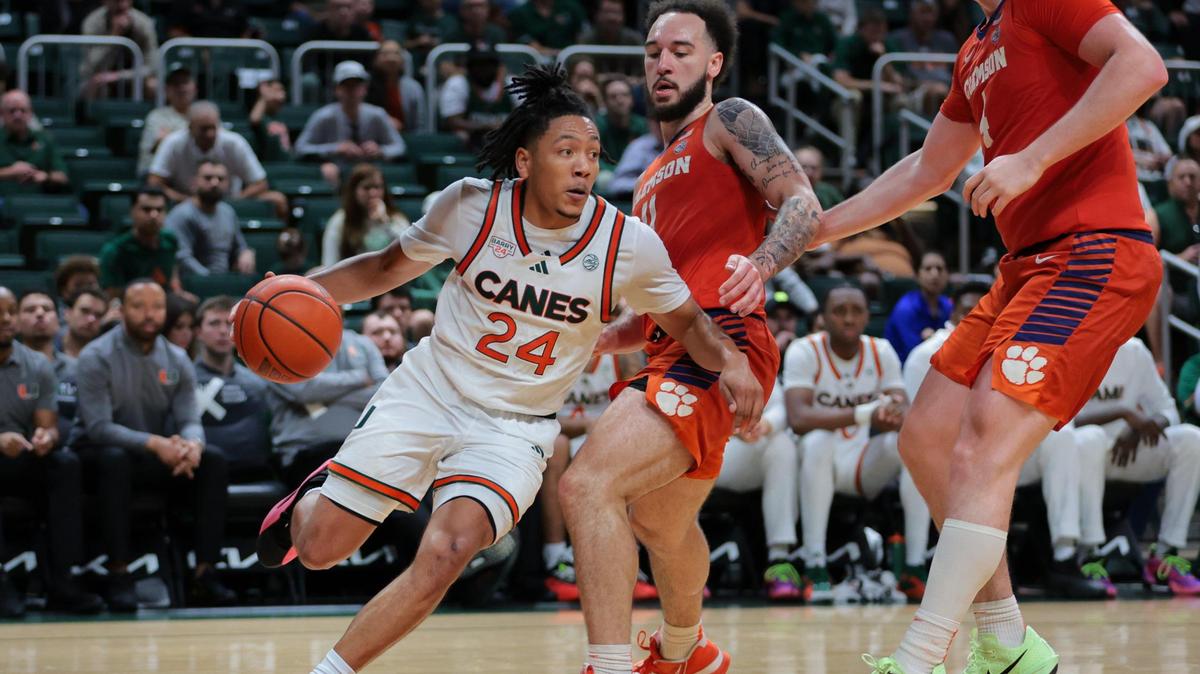 Miami Hurricanes guard Nijel Pack (24) drives to the basket past Clemson Tigers guard Jaeden Zackery (11) during the second half at Watsco Center in Coral Gables, Florida, on Saturday, December 7, 2024. Pack shot 0-for-7 from three-point range and was held scoreless for the game.
