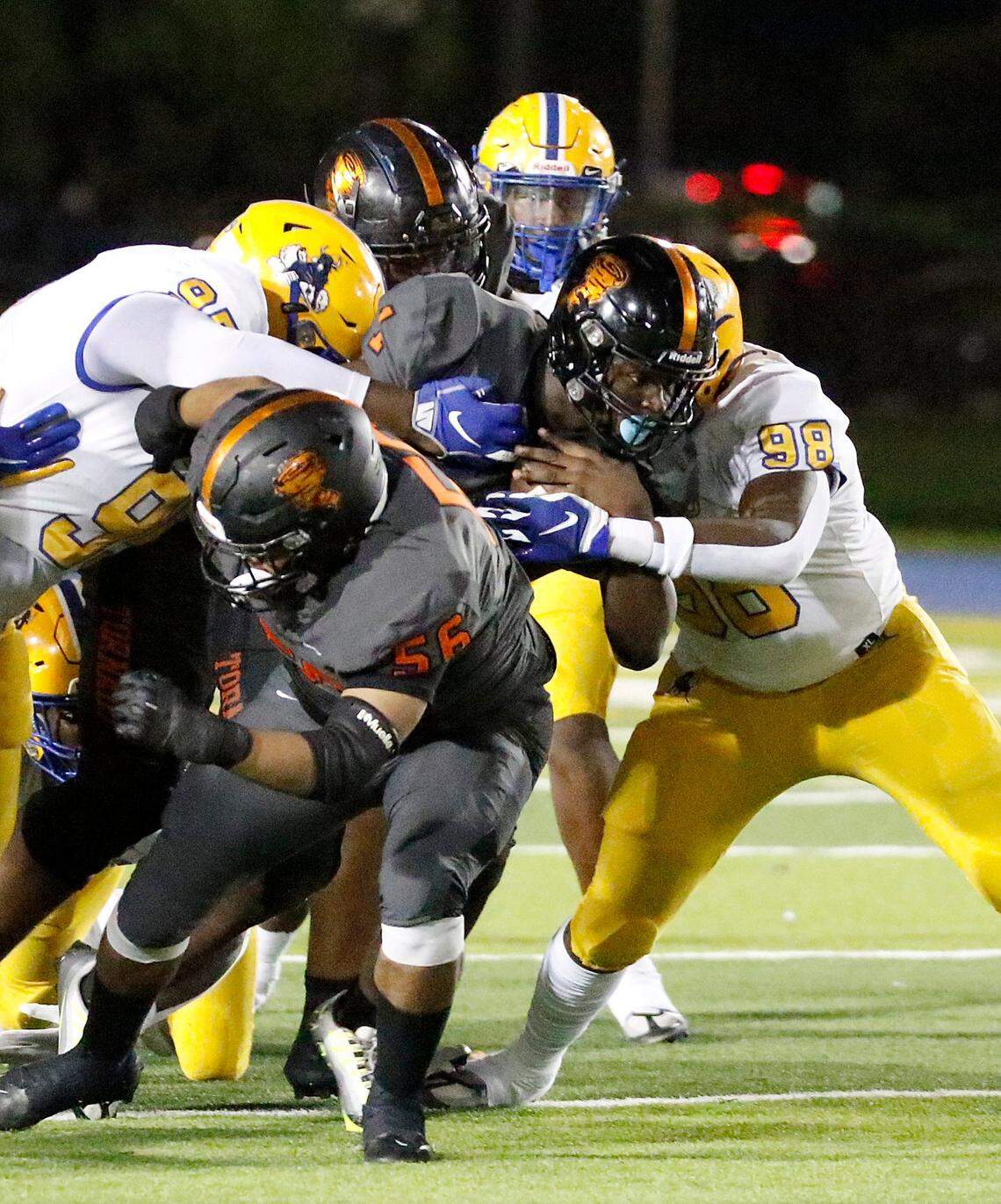 Northwestern Bulls defenders tackle Booker T. Washington Tornadoes ball carrier during football game on Saturday, October 15, 2022 at Traz Powell Stadium in Miami. Andrew Uloza / for Miami Herald