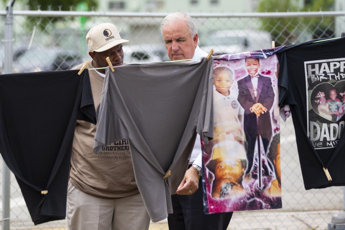 Leroy Jones, left, a leader of the Circle of Brotherhood and Neighbors and Neighbors Association, during a 2019 tour of a memorial for victims of gun violence in Liberty City with Carlos Gimenez, then the mayor of Miami-Dade County.
