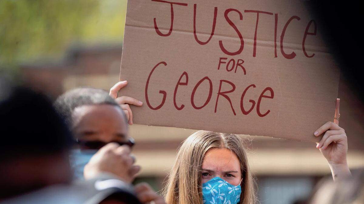 Woman joins others to protest the death of George Floyd at the hands of Minneapolis police.