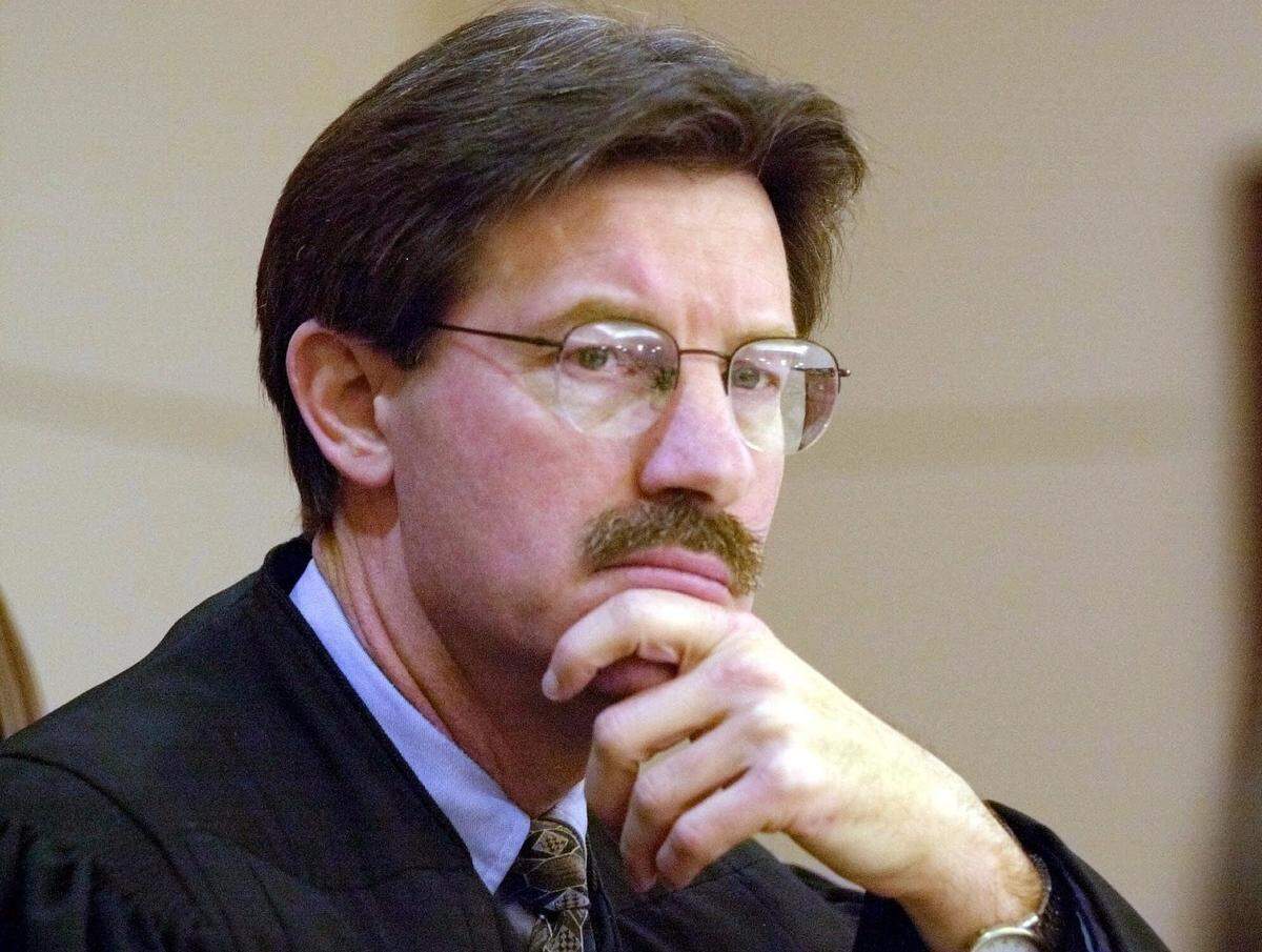 Leon County Circuit Judge Terry Lewis listens to testimony in his courtroom in Tallahassee, Fla., Thursday, Dec. 7, 2000. Lewis is hearing the Martin County absentee ballot application case. The case ruled on by the Florida Supreme Court Friday, Dec. 8, 2000, has now been assigned to Lewis after Judge N. Sanders Sauls recused himself. (AP Photo/Mark Foley, Pool)