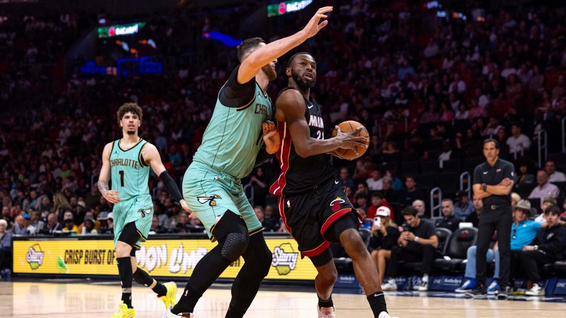 Miami Heat forward Andrew Wiggins (22) drives on Charlotte Hornets center Jusuf Nurkic (11) during the second half of an NBA game at Kaseya Center on Sunday, March 23, 2025, in Miami, Florida.