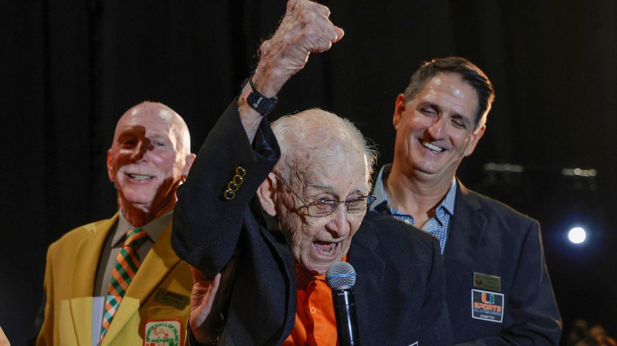 Canes fan G. Holmes Braddock, 98, gives a fist bump as he is honored during the University of Miami’s Sports Hall of Fame and Museum Induction Banquet.