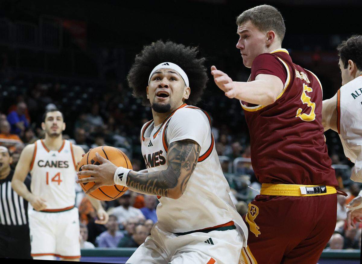 Miami Hurricanes guard Tre Donaldson (3) looks towards the basket as ULM Warhawks forward Renars Sondors (5) defends in the second half during their NCAA basketball game at Watsco Center, at the University of Miami campus in Coral Gables, Florida on Saturday, December 13, 2025.