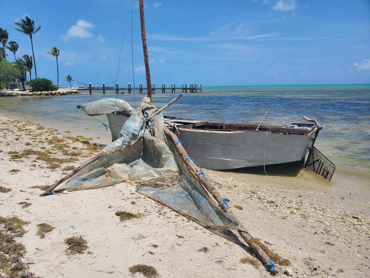 A migrant sailboat is beached on Lower Matecumbe Key Monday, May 2, 2022. The Border Patrol said 11 people from Cuba were on the vessel.