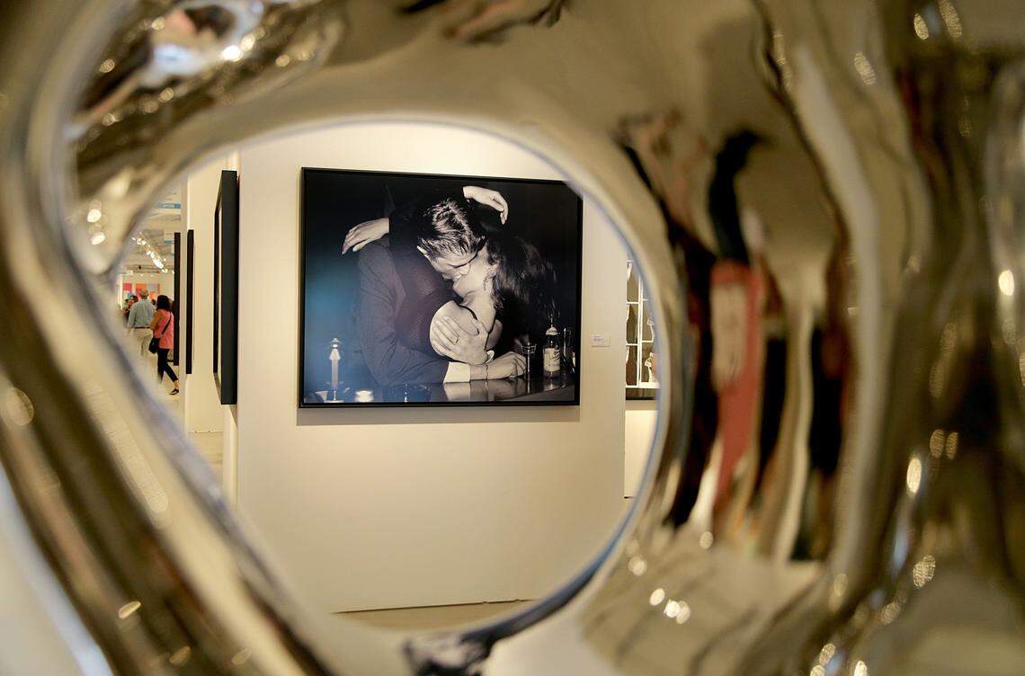 View of the piece “Berlin Kiss” by photographer Harry Benson on display at Holden Luntz Gallery through the piece “Uovum” by artist Roger Reutimann on display at Dean Project Gallery, during the Art Miami Fair 2018 in downtown Miami taking place December 4 - 9, on Friday December 07, 2018.