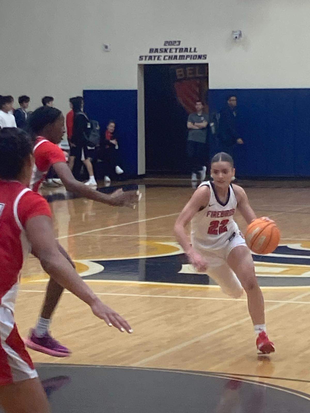 Doral’s Ashley Martinez drives the lane past St. Johns defenders to score two of her 18 points on Tuesday night in the Junior Orange Bowl girls’ basketball championship game.