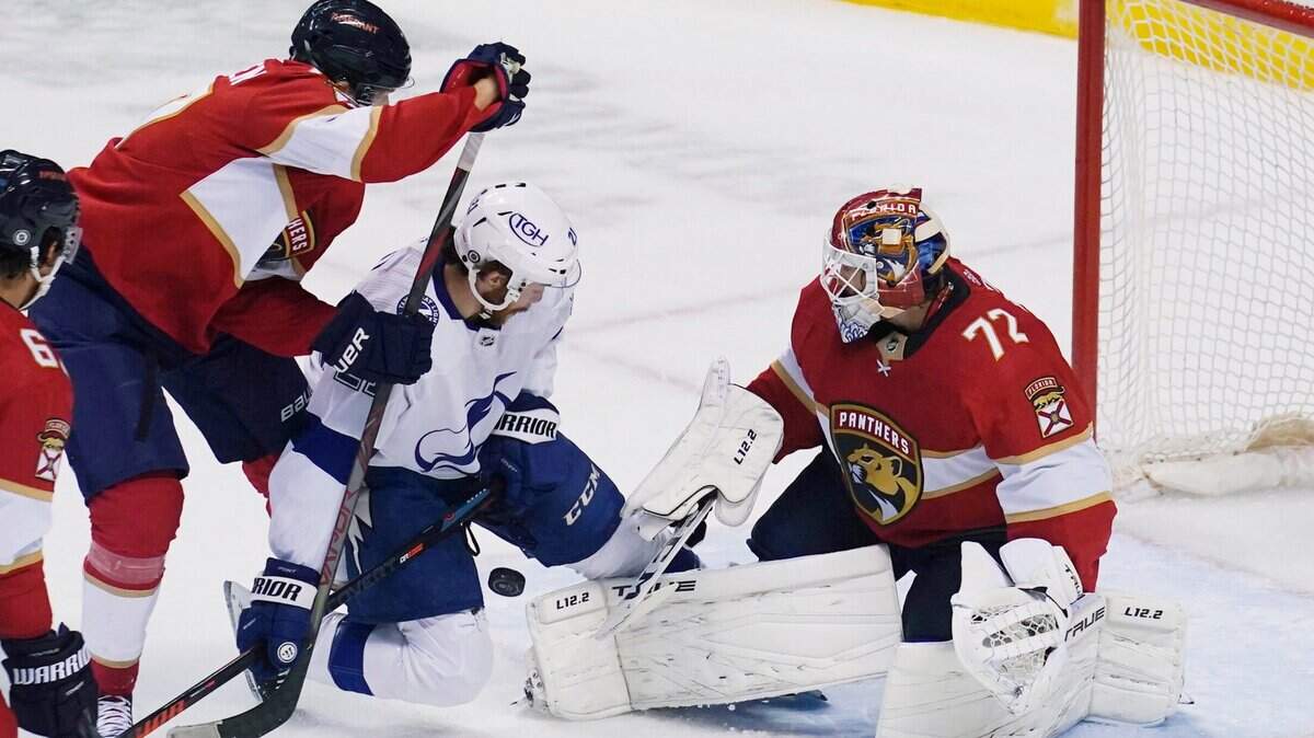 Tampa Bay Lightning center Brayden Point (21) crashes into Florida Panthers goaltender Sergei Bobrovsky (72), who stops a shot during the first period of an NHL preseason hockey game Saturday, Oct. 9, 2021, in Sunrise, Fla. (AP Photo/Marta Lavandier)