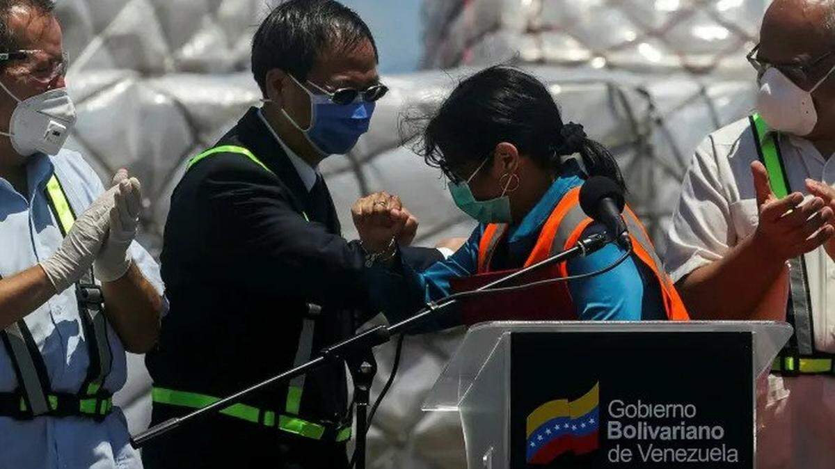 China’s ambassador to Venezuela, Li Baorong, left, bumps elbows with Vice President Delcy Rodriguez after a Chinese humanitarian aid shipment in March.