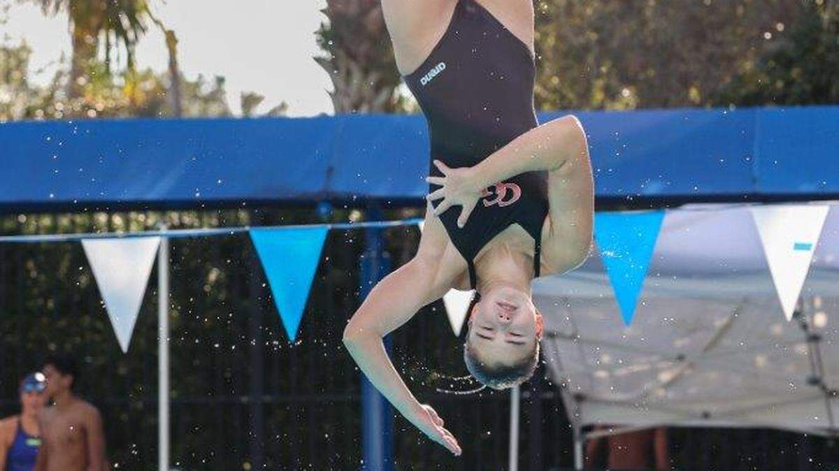 Cardinal Gibbons diver Juliet Radich, seen here in mid-dive, broke the state’s 1-meter springboard diving record at the Region 4-2A meet with a final score 544.25.