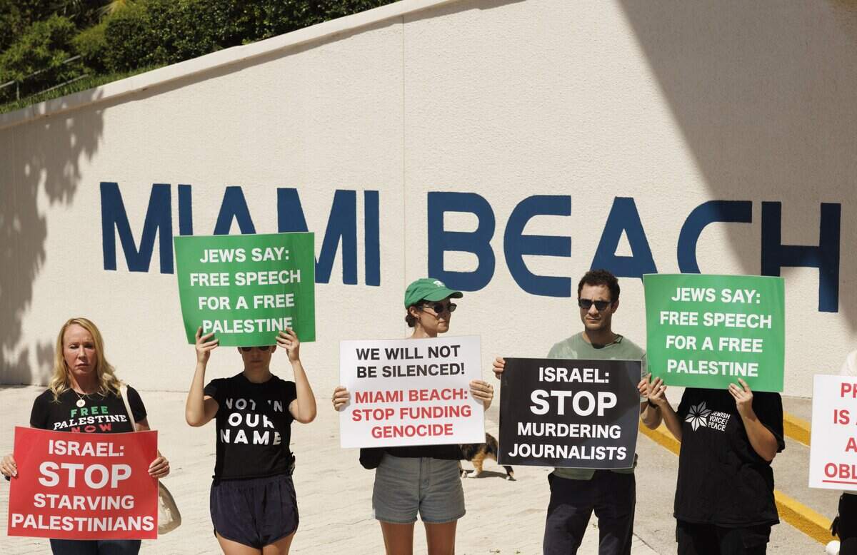 People with Jewish Voice for Peace hold signs during a press conference about a lawsuit they're bringing against the city of Miami Beach over a law restricting protests on Wednesday, Sept. 10, 2025 in Miami Beach, Fla.