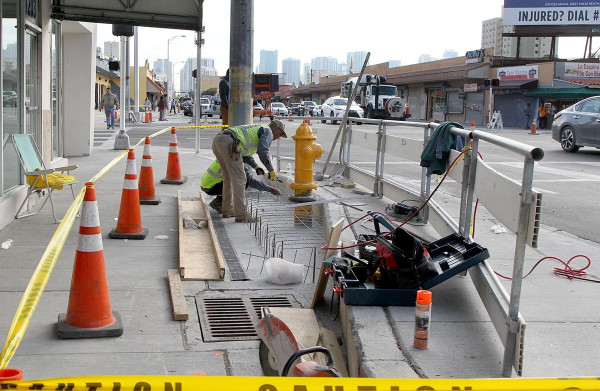 Construction crews set some wire nets up to pour concrete around a water hydrant at the intersection of Flagler Street and 12th Avenue Tuesday. The concrete work is among the last details of road work that dragged on and took some small businesses down with it.