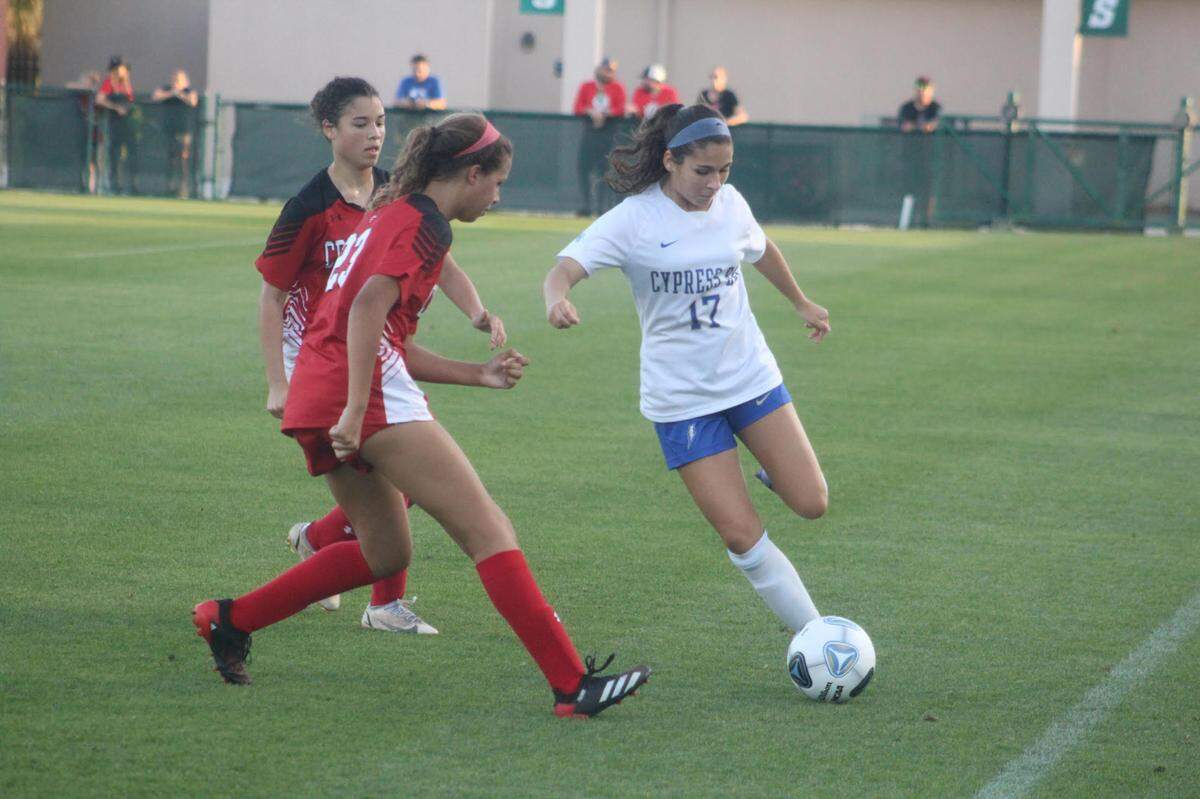 Cypress Bay midfielder Antonella Solari tries to outrace Creekside defenders to the ball during Friday afternoon’s Class 7A state championship game at Spec Martin Stadium in DeLand. The Lightning lost 3-1.