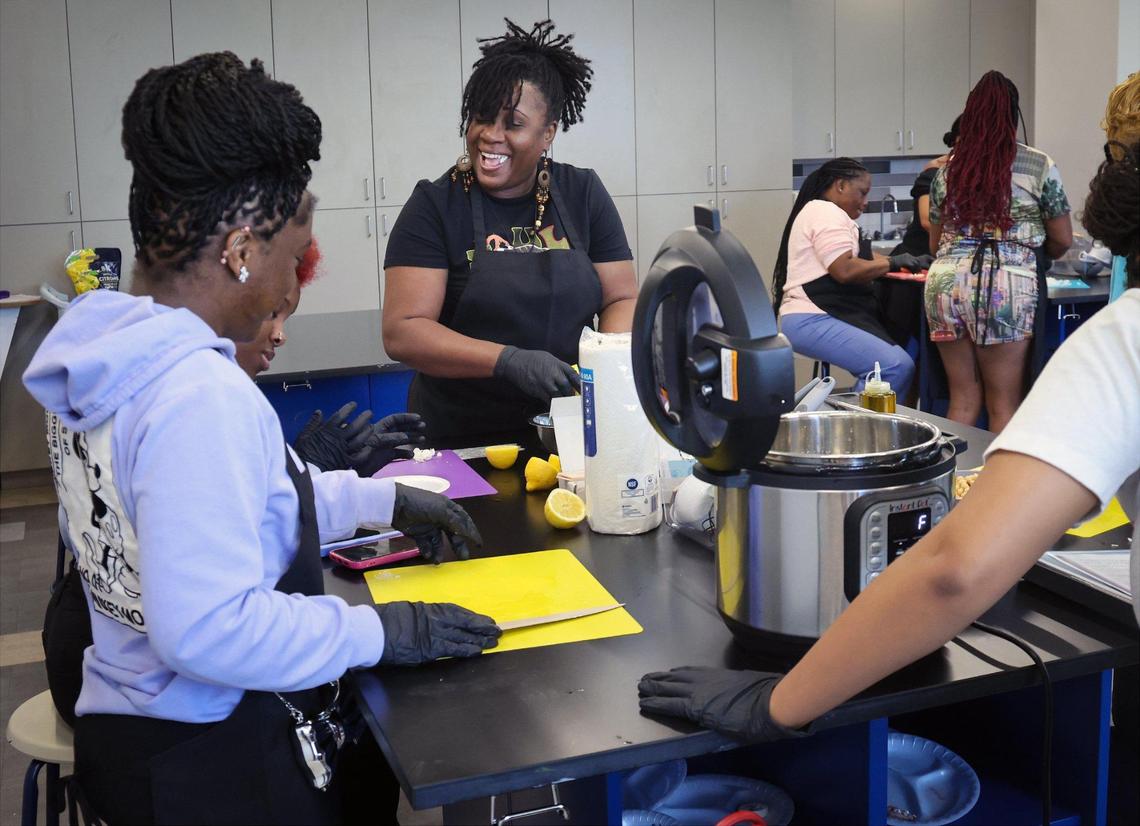 Tiffany Brooks, center, enjoys the act of cooking with members of “Sweet and Sour” cooking group during a cooking class that is part of a pilot program launched at the Overtown Youth Center by Miami Beach resident Dan Buettner, host and co-producer of Netflix’s Emmy Award-winning series “Live to 100: Secrets of the Blue Zones,” on April 3, 2025, in Miami, Florida.
