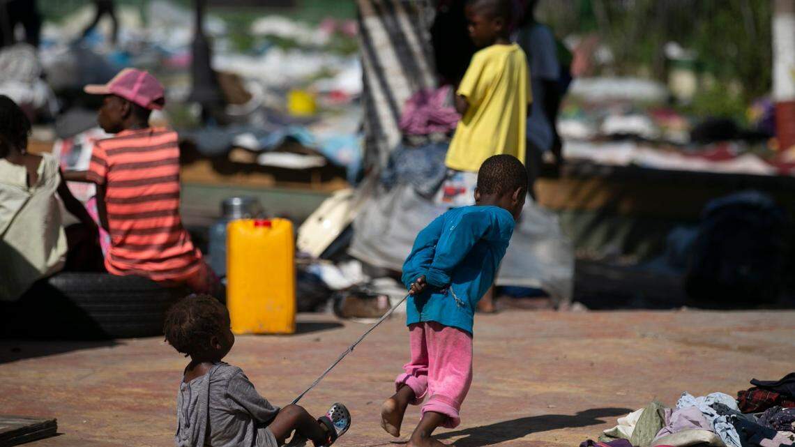 A child playfully pulls another child with a rope at the Hugo Chavez public square, which has been transformed into a refuge for families forced to leave their homes due to clashes between armed gangs in Port-au-Prince, Haiti, Thursday, Oct. 20, 2022.