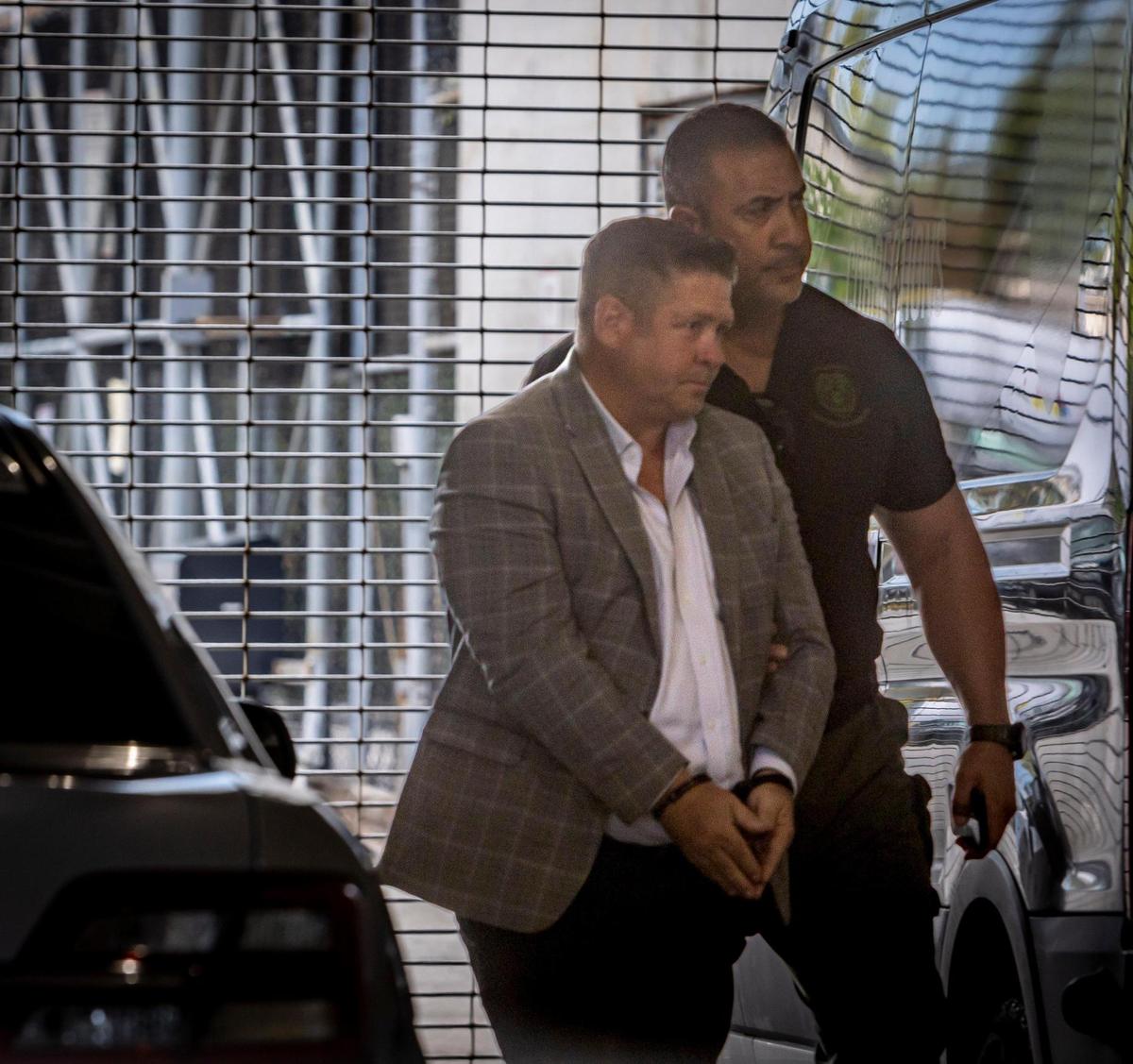 Attorney and lobbyist Bill Riley is lead into TGK in handcuffs after he was charged with money laundering and bribery on Thursday, Sept. 14, 2023.