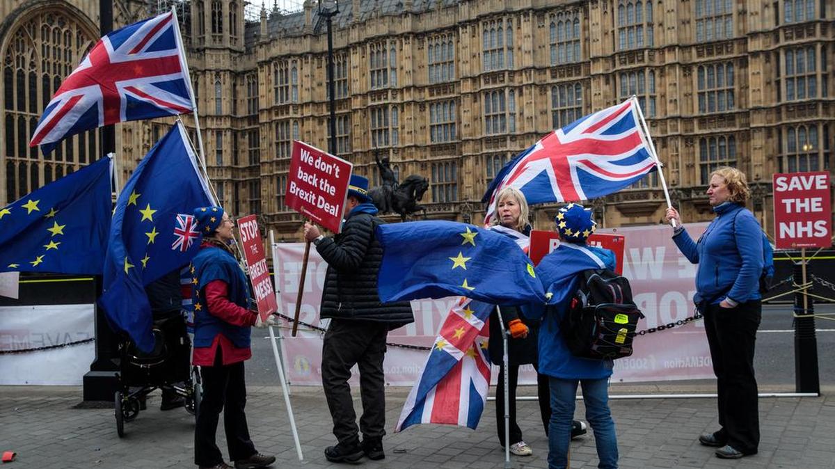 Anti-Brexit protesters demonstrate with flags outside the Houses of Parliament in Westminster on Jan. 7 in London, England. In the week ahead, a series of votes in Parliament are scheduled. First up is the Tuesday decision on the government’s official Brexit plan.