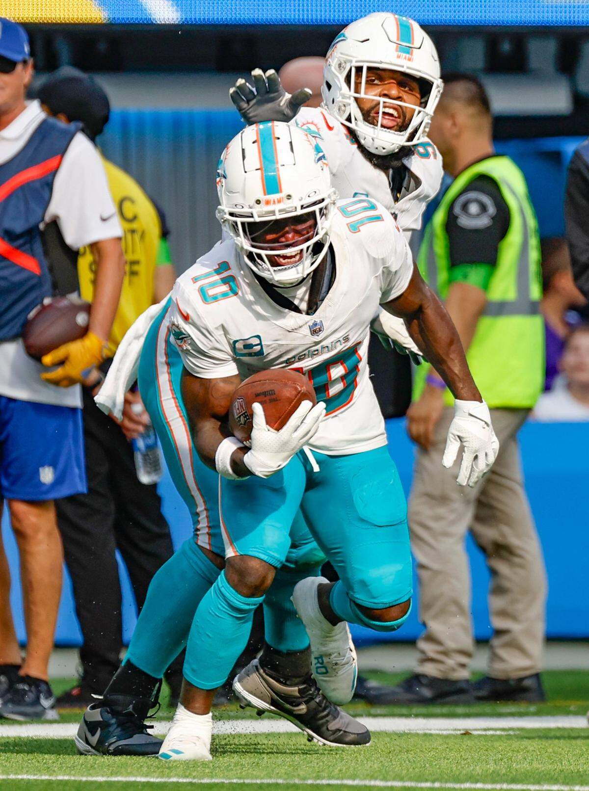 Miami Dolphins wide receiver Tyreek Hill (10) and Miami Dolphins defensive tackle Christian Wilkins (94) celebrate Hill’s touchdown late in the fourth quarter against the Los Angeles Chargers at SoFi Stadium in Inglewood, California on Sunday, September 10, 2023.