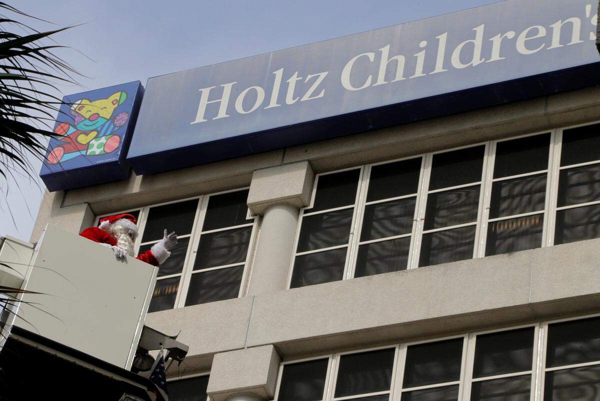 Santa Claus greets a group of young patients at Holtz Children’s Hospital and Jackson Memorial Hospital during a parade accompanied by the marching band from Hialeah-Miami Lakes High School performing holiday favorites. Santa arrived on a City of Miami Fire Rescue Department truck, was lifted on a telescopic hook-and-ladder toward the windows of Holtz Children’s and waved to patients inside on Dec. 4, 2018.