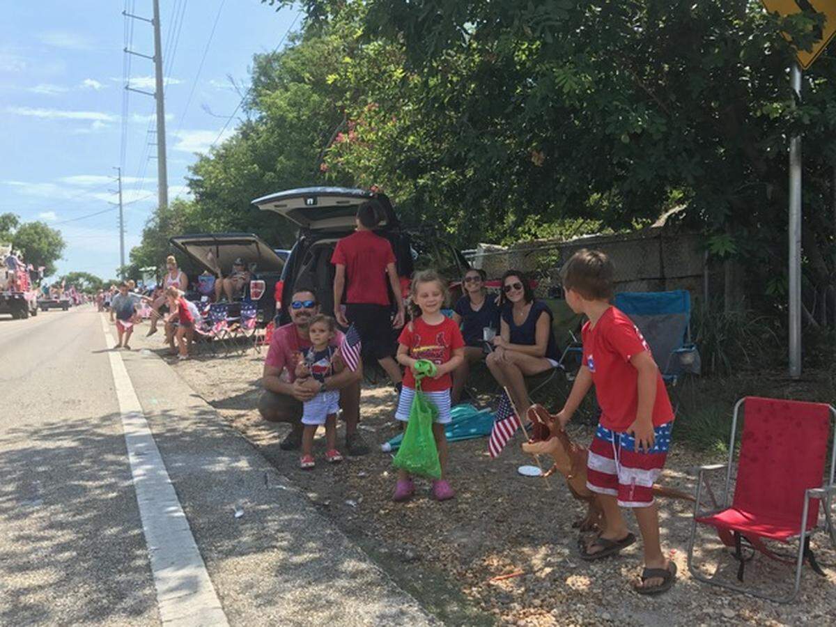 Participants in the Key Largo Fourth of July Parade throw candy, beads, and other treats at people lined up to watch the floats Wednesday, July 4, 2018. The annual parade shuts down the northbound lanes of U.S. 1 to traffic starting at mile marker 97.