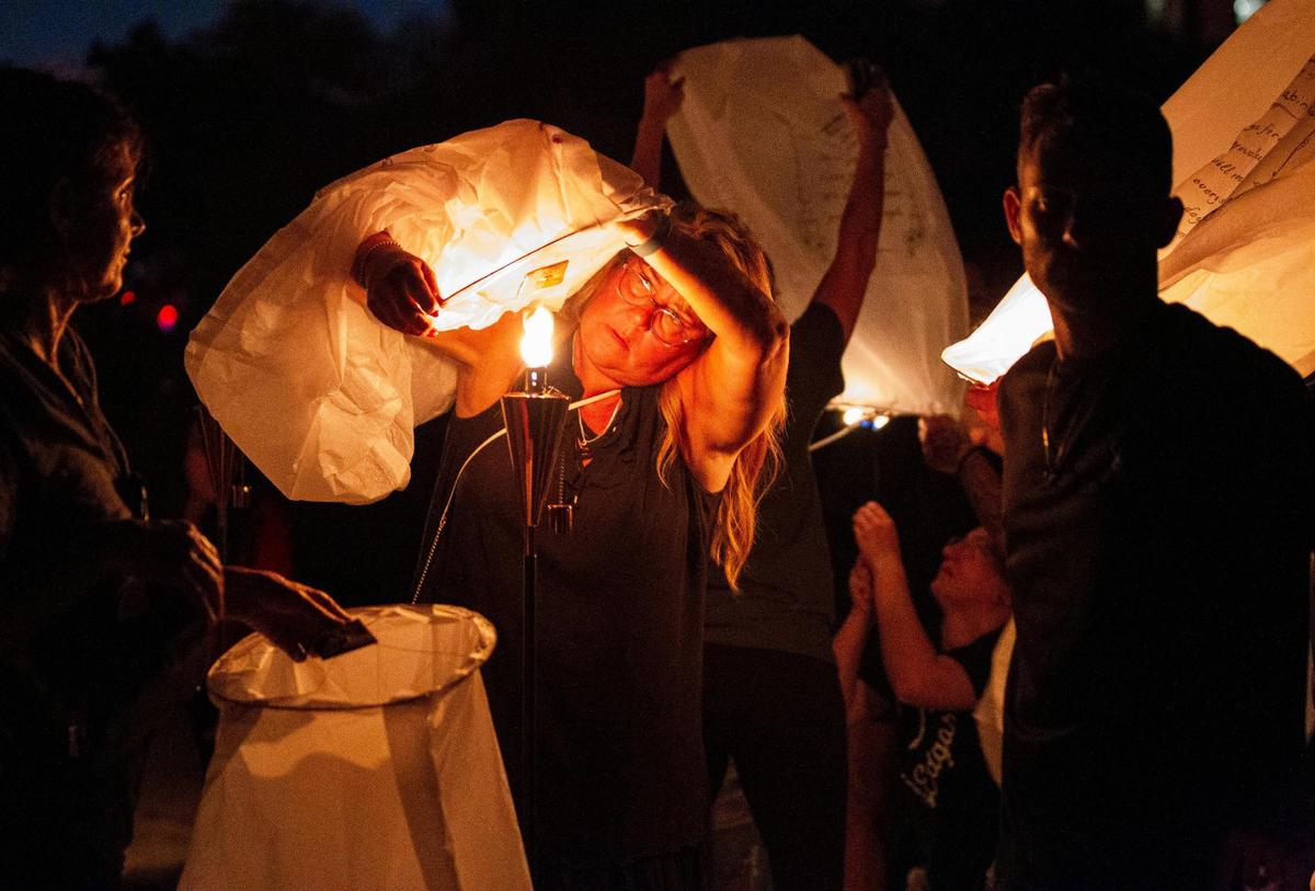 Debbie Hill lights a lantern during an event honoring lives lost in the collapse of Champlain Towers South two years ago on Saturday, June 24, 2023 in Surfside, Florida. Hill’s father, Richard Augustine, died in the collapse.