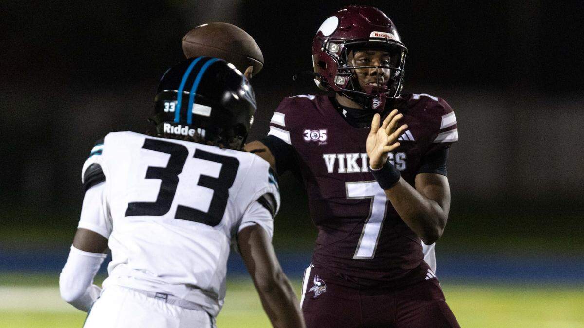 Norland Vikings quarterback Kai Moore (7) throws the ball as Archbishop McCarthy defensive end Isaiah Cunningham (33) rushes during a high school football game at Traz Powell Stadium on Thursday, September 25, 2025, in Miami, Fla.