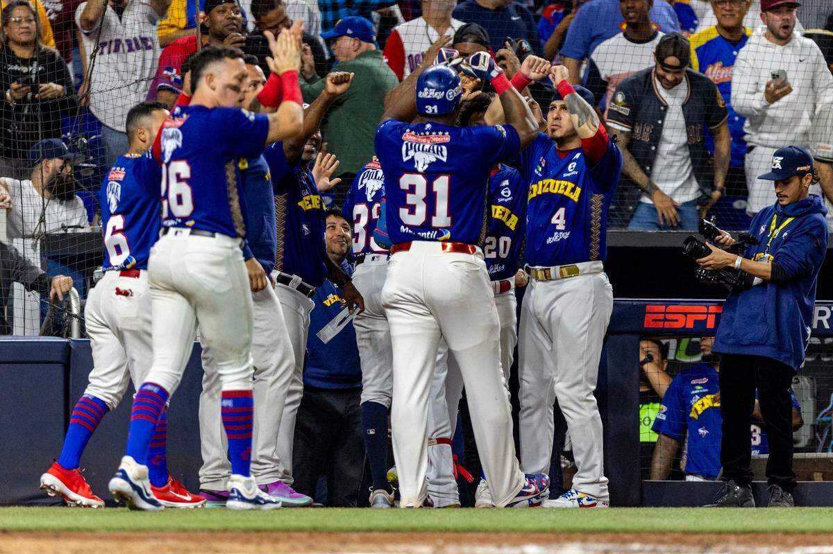Venezuela players react with Yasiel Puig (31) and Ramon Flores (33) after the two scored runs during the fourth inning of a Caribbean Series Semi Final baseball game against Curacao at loanDepot park in Miami, Florida, on Thursday, February 8, 2024.