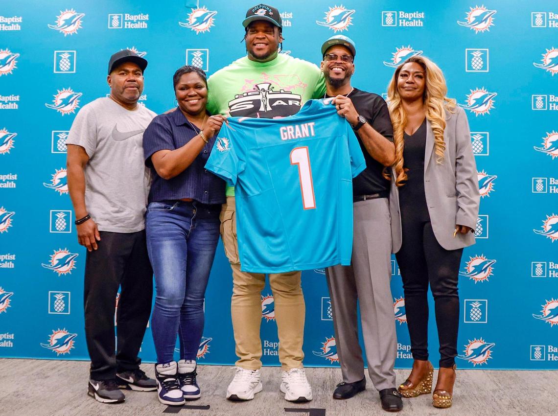 Dolphins 13th overall draft pick, Michigan defensive tackle Kenneth Grant, poses with his family during a press conference in Miami Gardens on Friday.