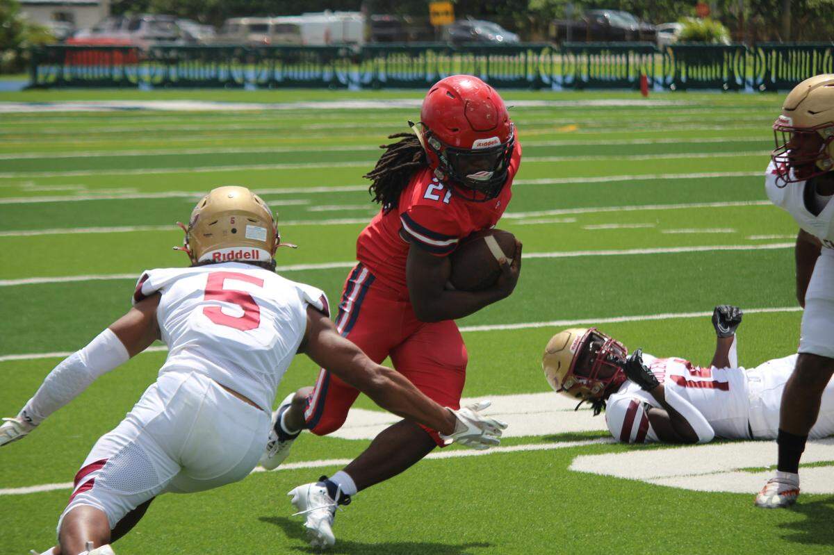 Goleman defender Damian Perez (5) moves in to tackle American running back Johnny Henderson during Wednesday afternoon’s concluded contest at Traz Powell Stadium.