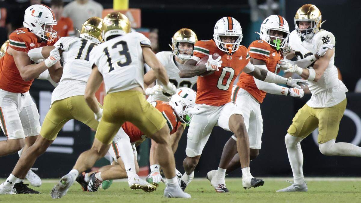 Miami Hurricanes wide receiver Joshisa Trader (0) carries the ball against the Notre Dame Fighting Irish in the second half of an NCAA football game at Hard Rock Stadium in Miami Gardens, Florida, on Sunday, August 31, 2025.