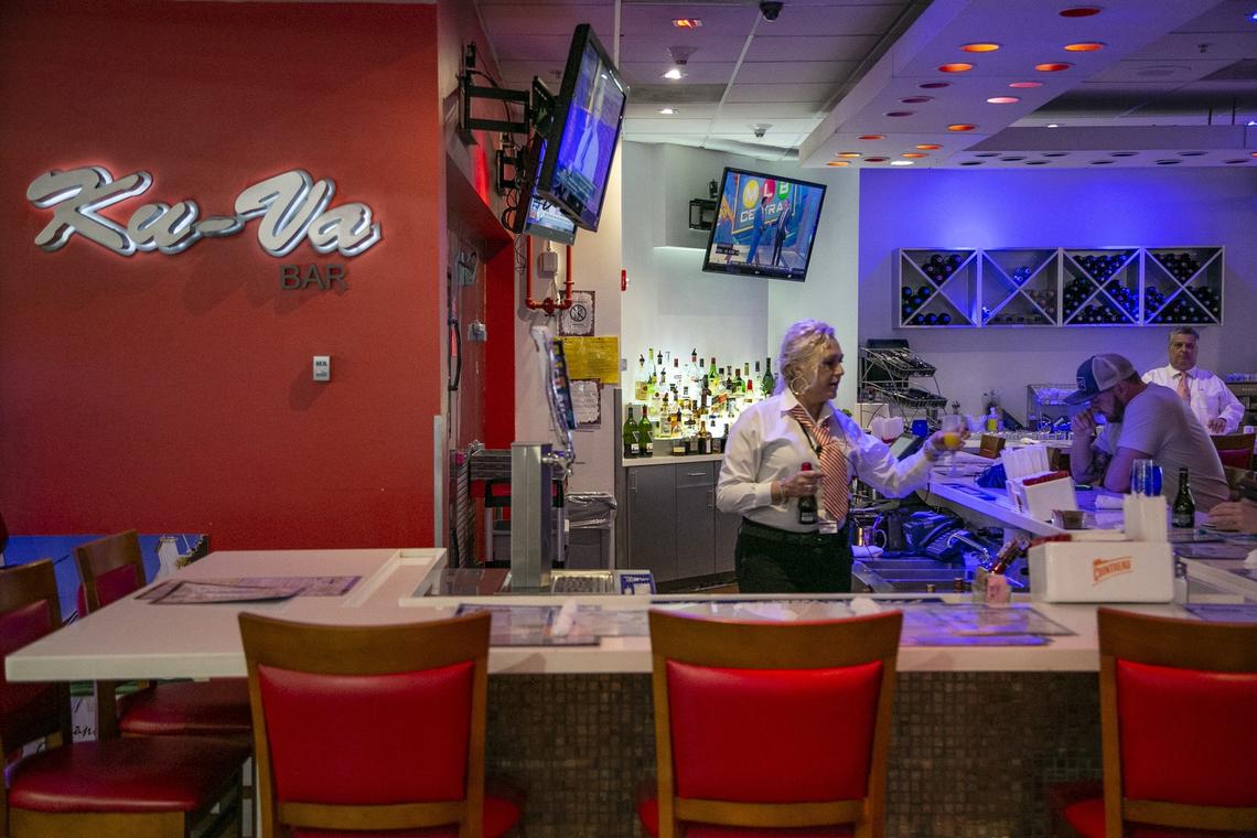 A server attends to customers at Ku-Va Restaurant & Bar at Miami International Airport on Thursday, April 4, 2019. Miami-Dade County is cracking down on automatic gratuities at restaurants at the airport.