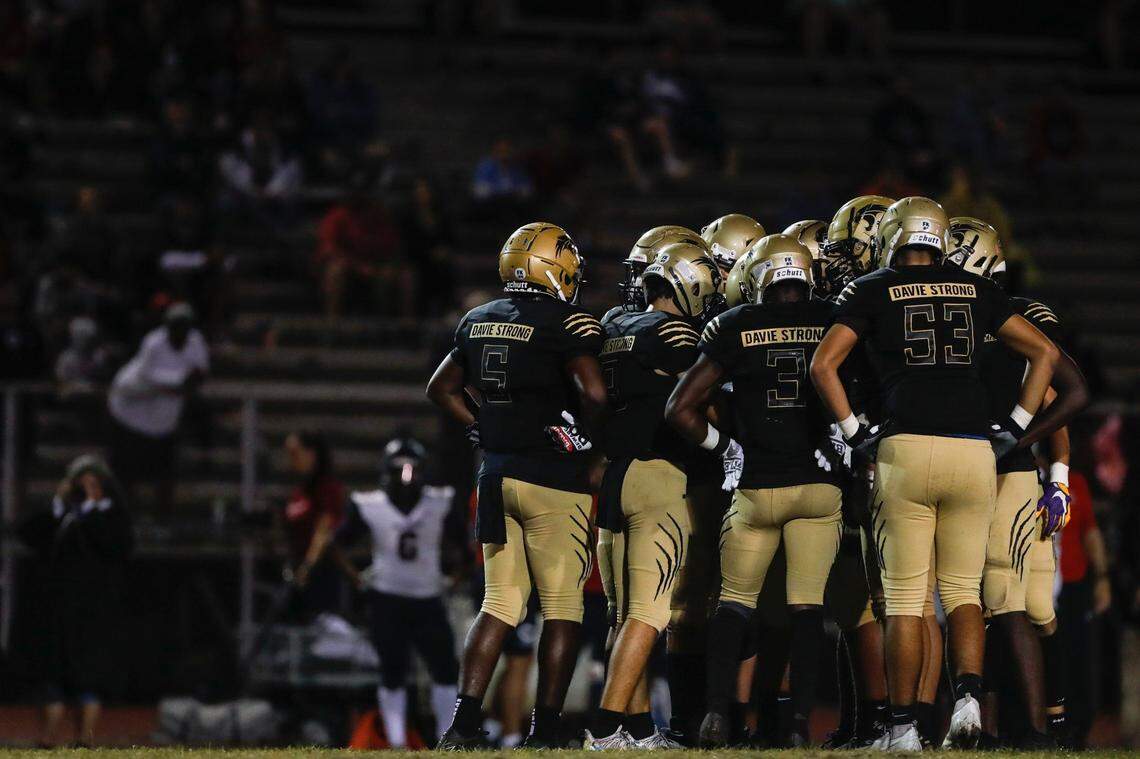 Western Wildcats players huddle prior a play against Columbus during a second-round high school football playoff game at Western High School in Davie, Florida on Friday, November 19, 2021.